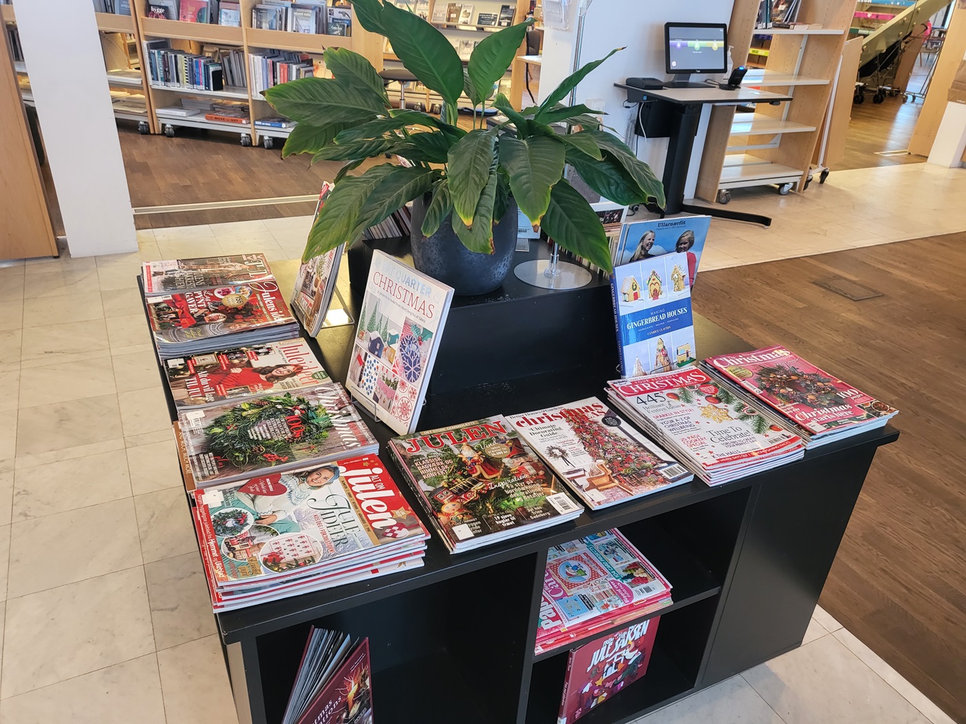 Many Christmas magazines on an exhibition desk